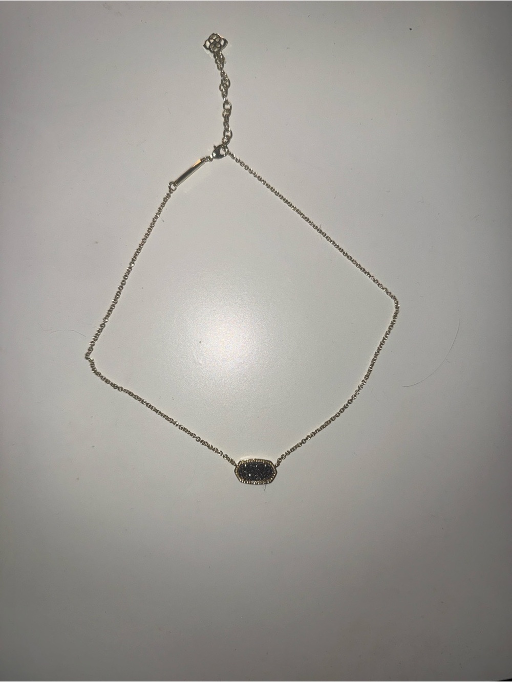 Kendra Scott Gold necklace with black sparkle gem